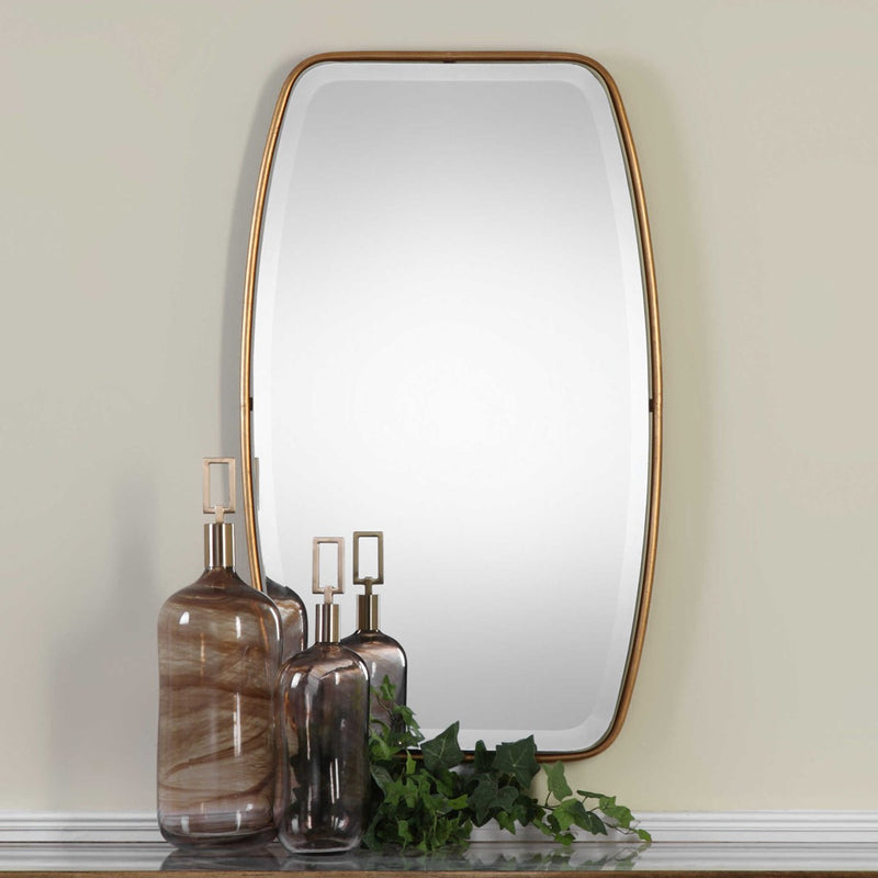 Uttermost 9145 Canillo antiqued gold mirror shown styled on a wall